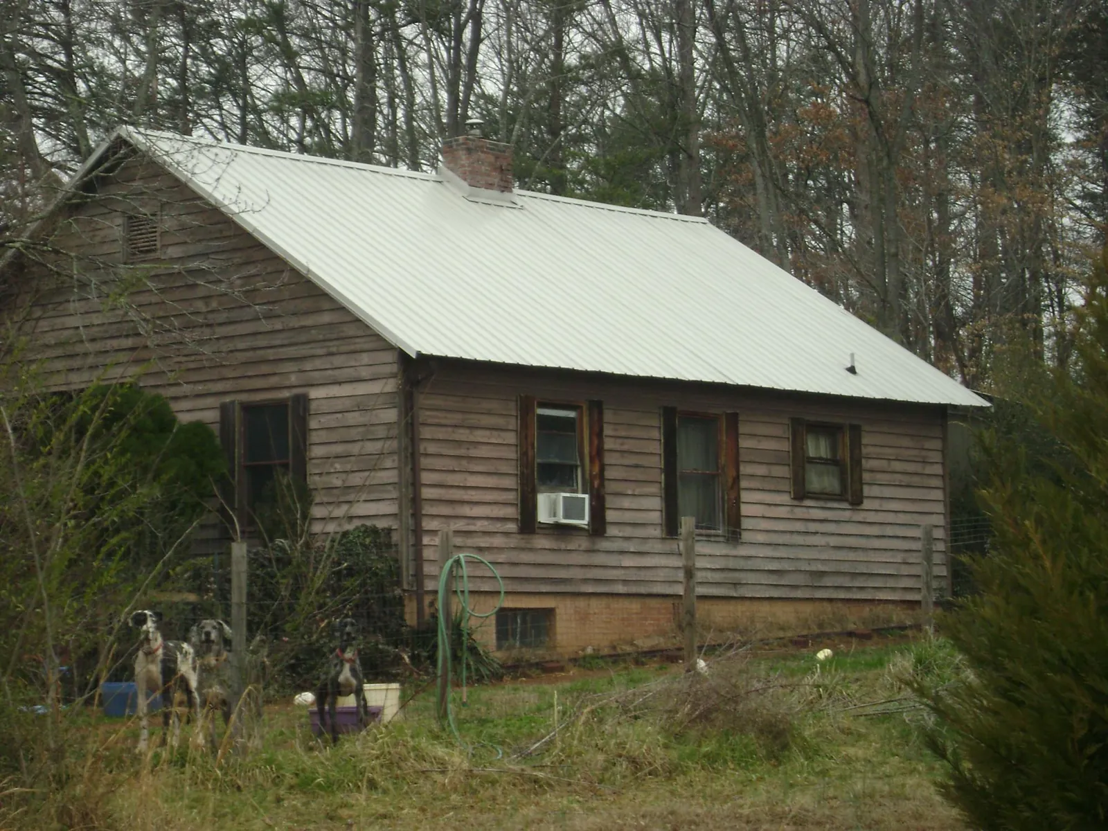 White metal roof on an old wood sided farmhouse, from a Metal Roof Installation job in Owings